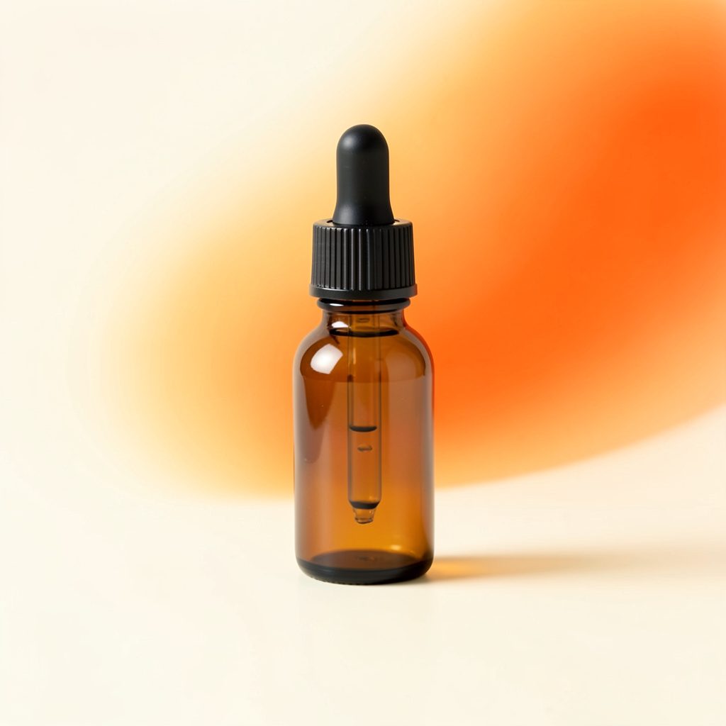 Small amber glass bottle with a dropper cap on a light surface, warm amber and cream tones