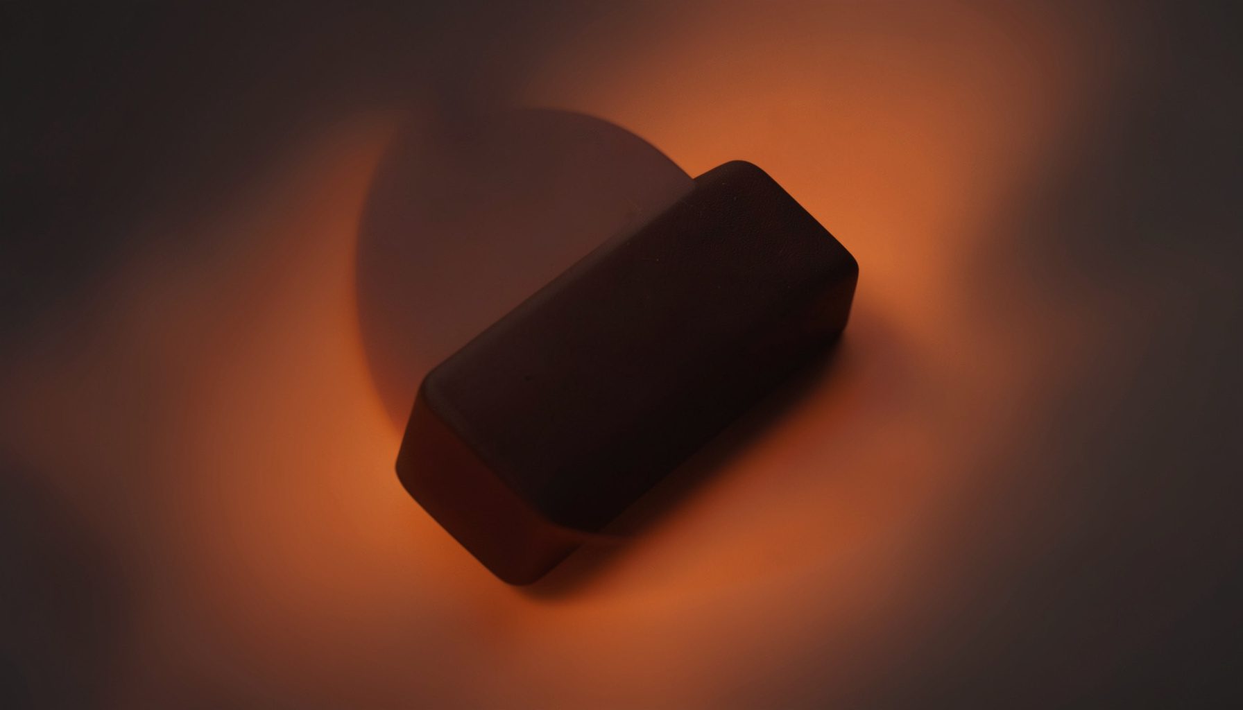 Dark chocolate bar with subtle textured surface on a moody background