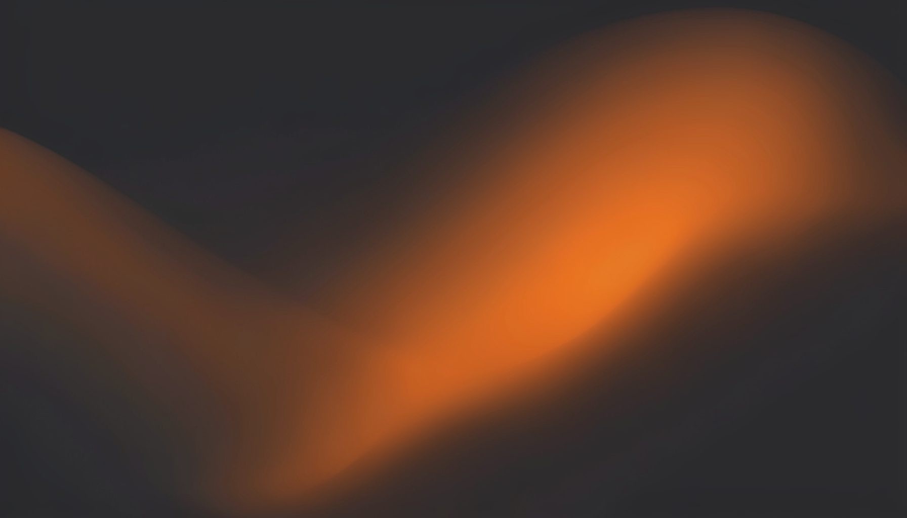Abstract gradient swatch in charcoal and burnt orange tones, moody with no objects